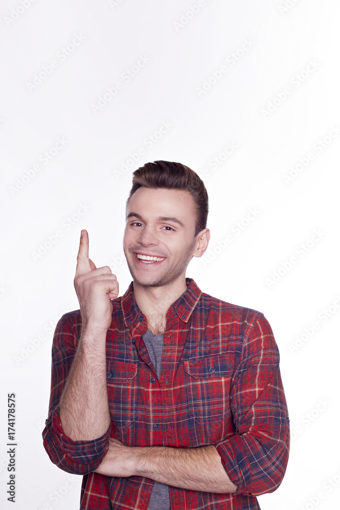 Portrait of young stylish freelancer in checkered shirt pointing on copyspace. Portrait of young stylish freelancer in checkered shirt pointing on copyspace.