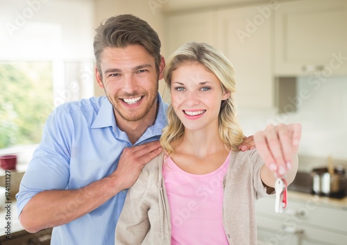 Couple Holding key in kitchen