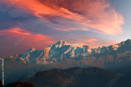 Red sunset sky with cirrostratus clouds over Himalayan Kedarnath mountain photo