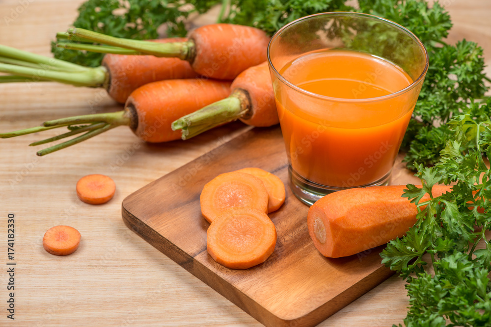 Glass of fresh carrot juice with vegetables on wooden table. Glass of fresh carrot juice with vegetables on wooden table.