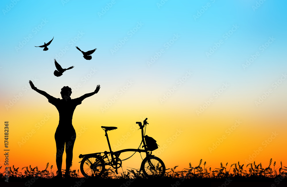 silhouette of bird flying out of lady and bicycle .blur background.peace concept. silhouette of bird flying out of lady and bicycle .blur background.peace concept.
