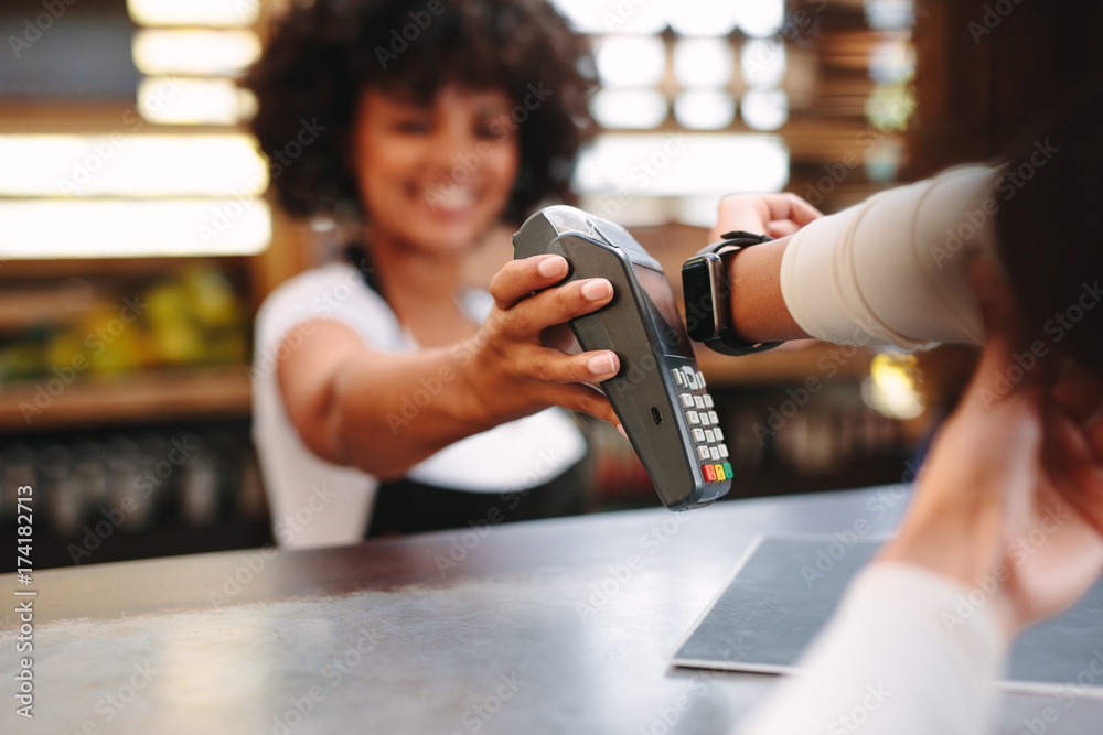 Fototapeta premium Customer paying bill using a smartwatch