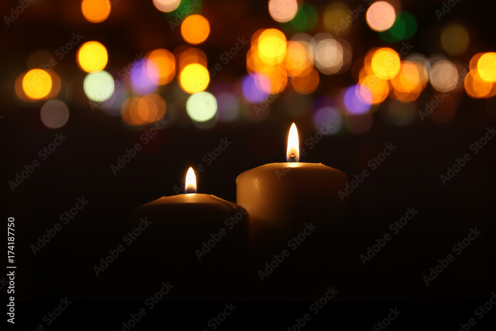Burning candles over black background with bokeh glitter lights Stock ...