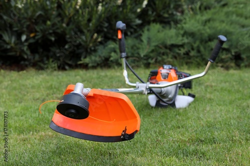 Brush cutter handles in the grass