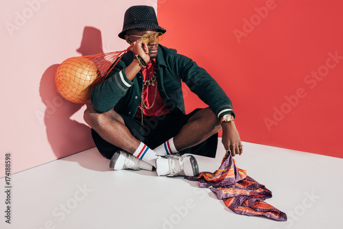 stylish african american man with ball