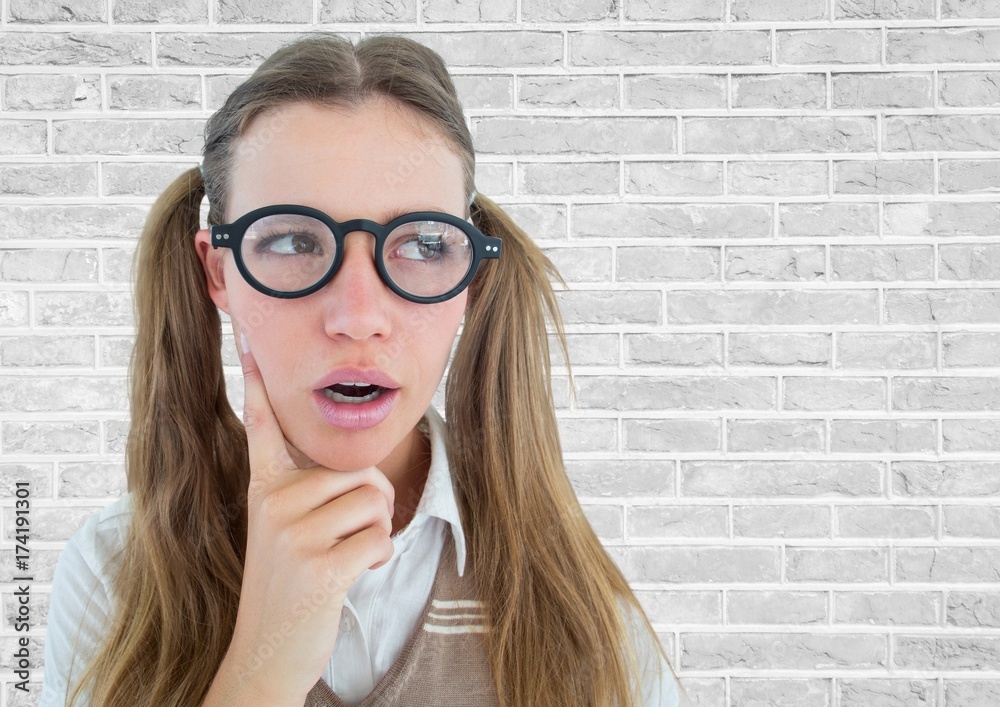 Close up of nerd woman thinking against white brick wall Close up of nerd woman thinking against white brick wall