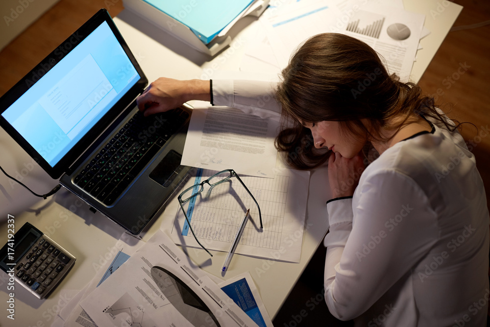 tired woman sleeping on office table at night tired woman sleeping on office table at night