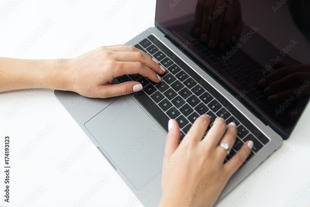 Women hands on the top of the table over laptop keyboard Women hands on the top of the table over laptop keyboard