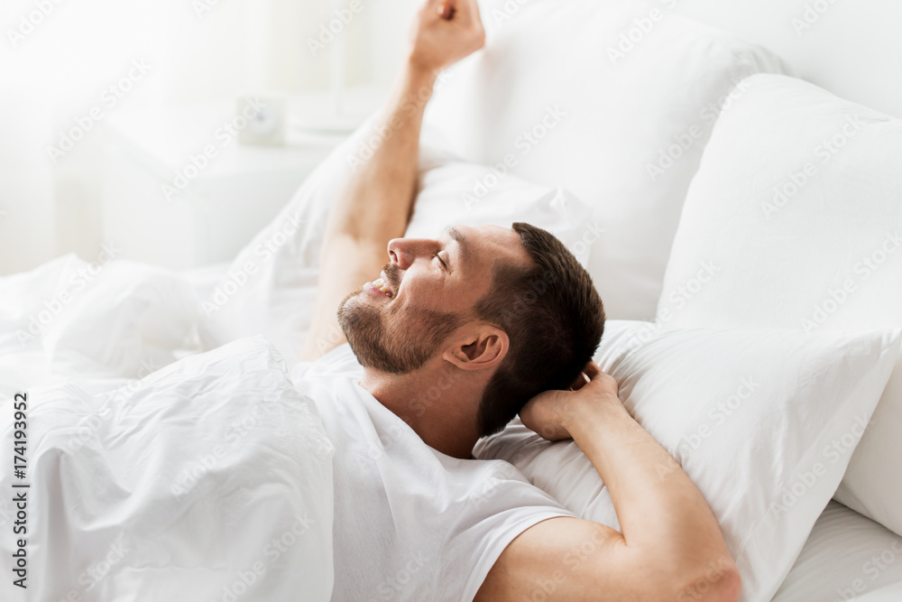 man lying in bed at home man lying in bed at home