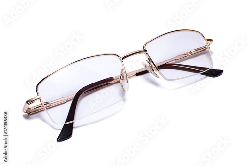 Gold-rimmed eyeglasses on white background