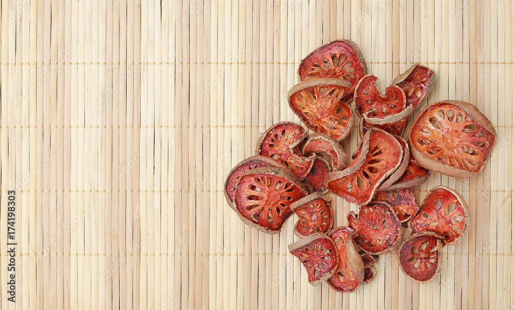 Pile sliced Bael dried on wood background with copy space. Top view. Pile sliced Bael dried on wood background with copy space. Top view.