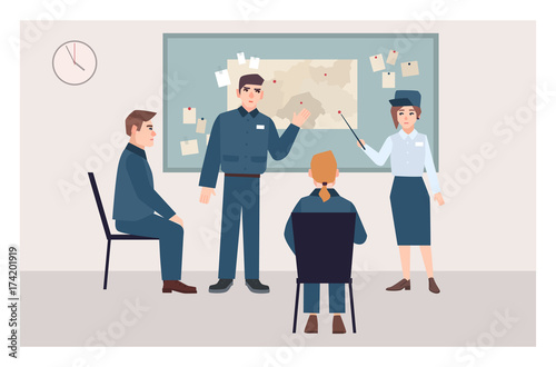Group of male and female police officers sitting on chairs and standing beside pin board