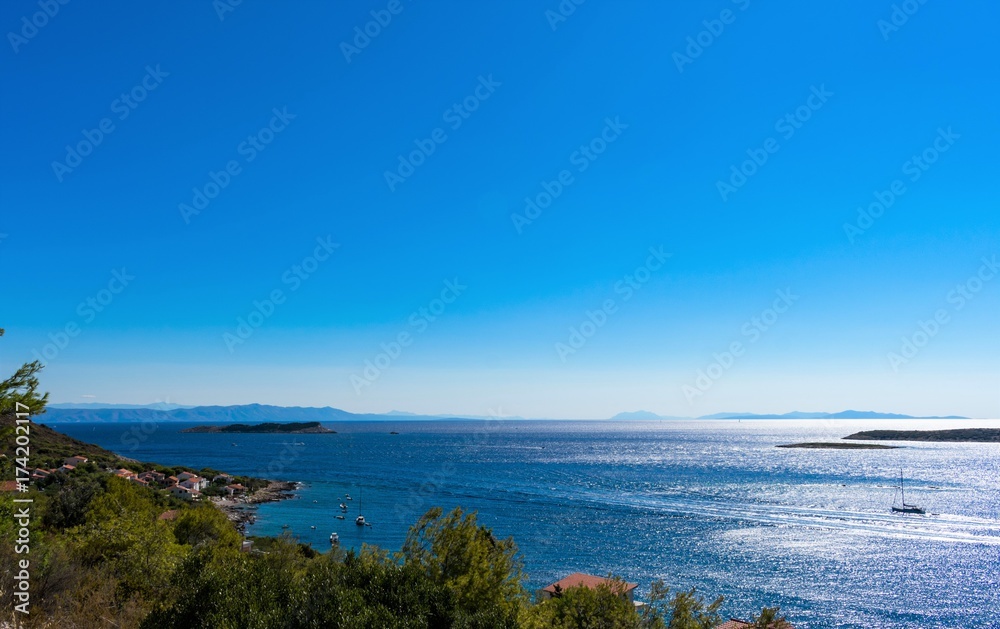 Panoramic view of sunrise above the Adriatic sea with islands and mountains on mainland in the background, Vis island in Croatia