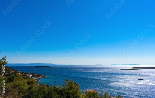Panoramic view of sunrise above the Adriatic sea with islands and mountains on mainland in the background, Vis island in Croatia