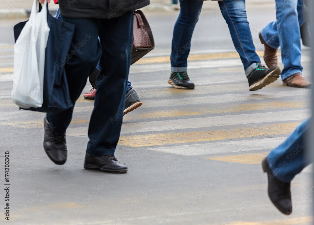 People on a pedestrian crossing. Feet and shoes, asphalt. People on a pedestrian crossing. Feet and shoes, asphalt.