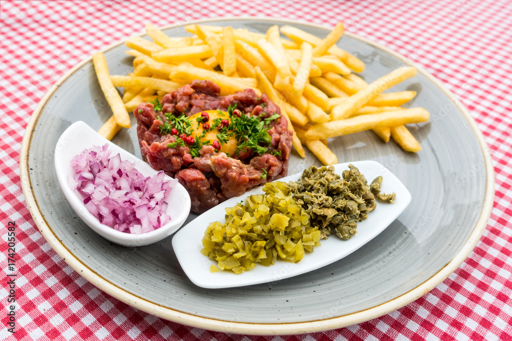 tasty Steak tartare (Raw beef) - classic steak tartare on white plate tasty Steak tartare (Raw beef) - classic steak tartare on white plate
