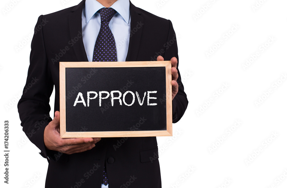 Businessman holding mini blackboard with APPROVE message Businessman holding mini blackboard with APPROVE message