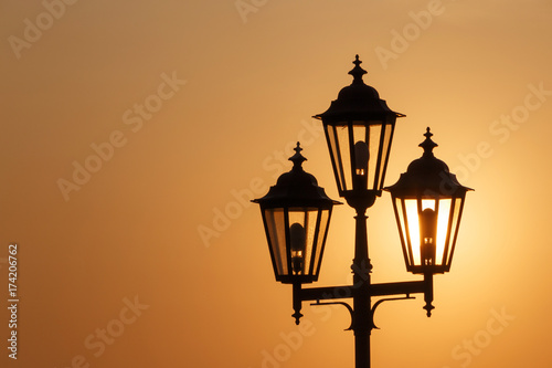 silhouette of lantern against rising sun in Odesa
