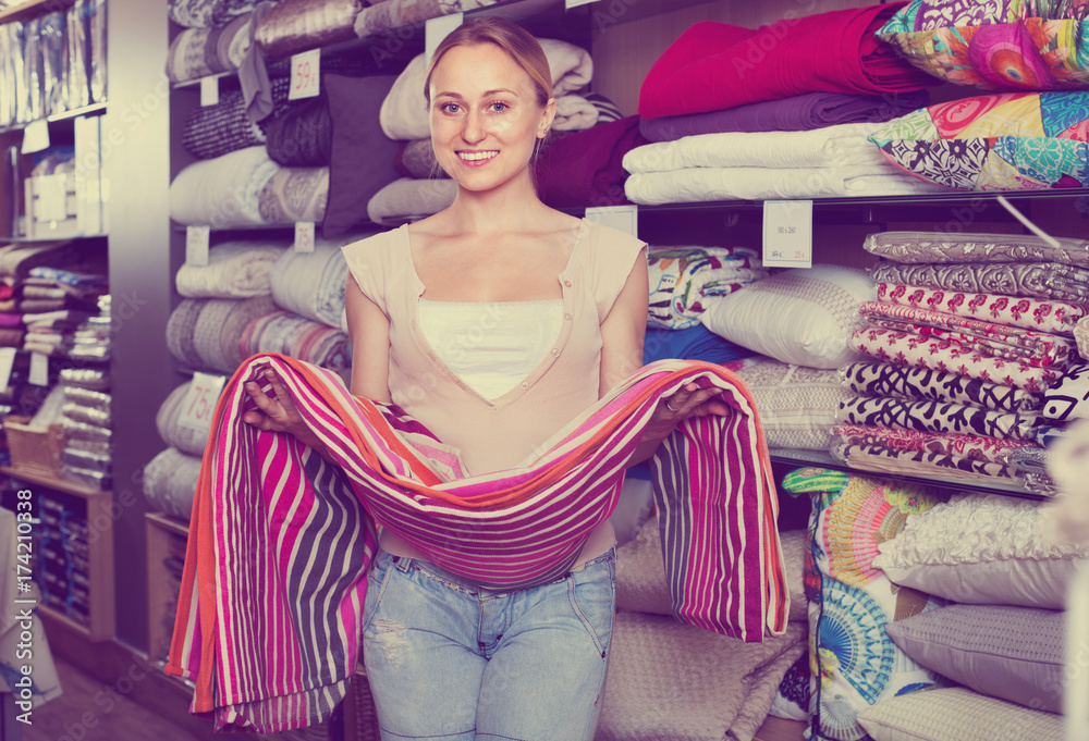 youngwoman-buying-bed-spread-in-textile-store-foto-de-stock-adobe-stock