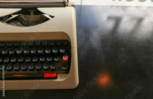 Manual vintage antique typewritter  on the black metal desk with copy space