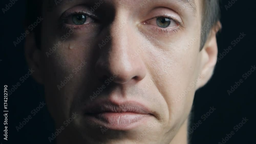 Close up portrait of crying man with tears