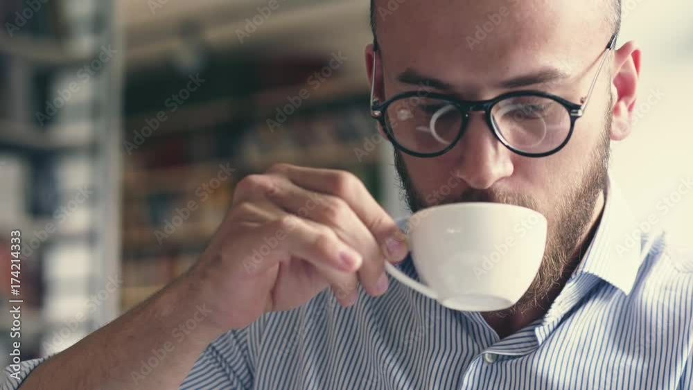 The young writer is drinking coffee The young writer is drinking coffee