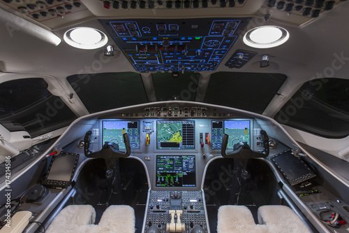 Instrument panels in cockpit of a very modern private business jet at night 