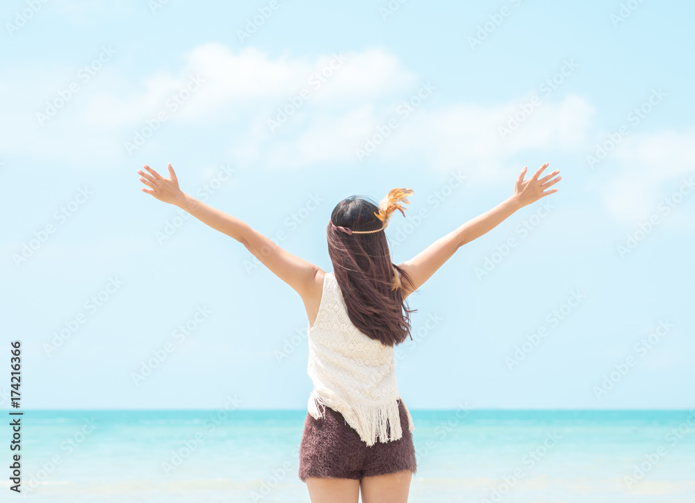 Happy young woman rising hands to sky at sea/beautiful beach, freedom, relaxing on vacation/holiday. Happy young woman rising hands to sky at sea/beautiful beach, freedom, relaxing on vacation/holiday.