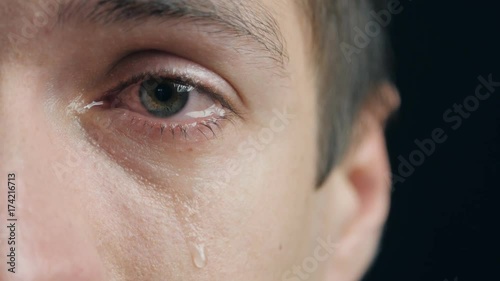 Shot of Crying man with tears in eye closeup