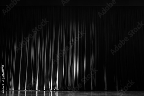 Black and white curtains with the lights of the show and the wood flooring parquet.