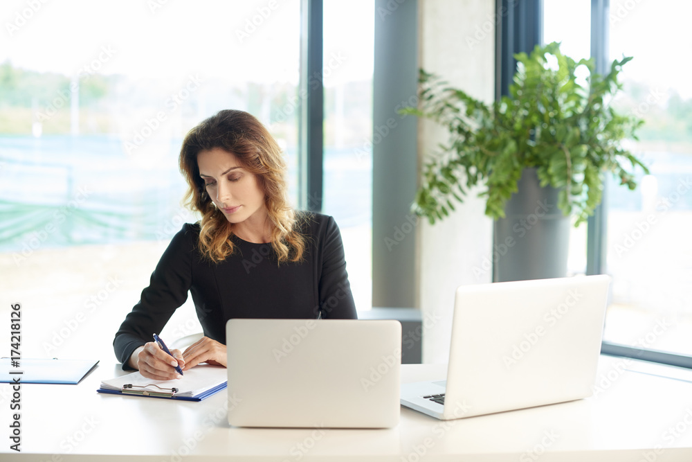 Manage financial business. Shot of a financial manager businesswoman working laptop at the office desk. Manage financial business. Shot of a financial manager businesswoman working laptop at the office desk.