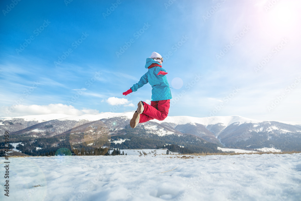 Young woman jumping in the mountains