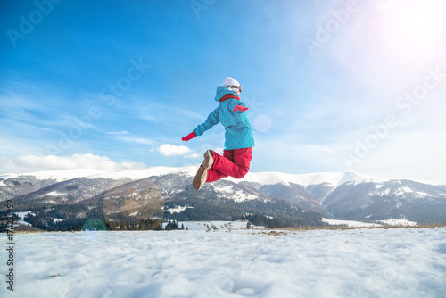 Young woman jumping in the mountains