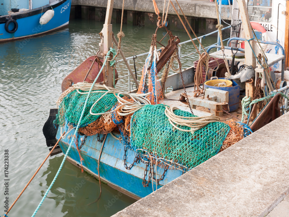 back of fishing boat with green fishing nets