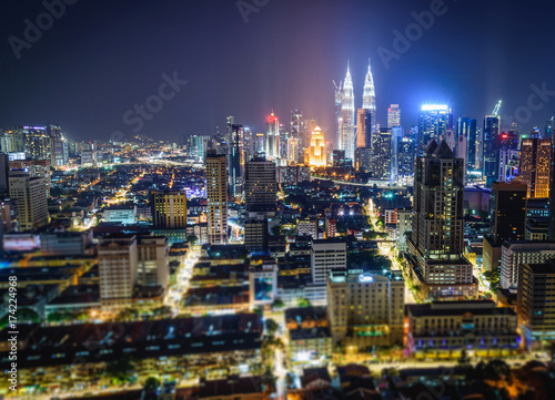 Cityscape of Kuala Lumpur city skyline at night in Malaysia. Tilt-shift effected photo.