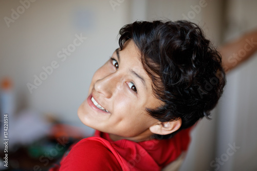 A young teenage boy smiles during his homework - shallow depth of field