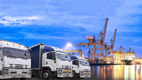 Shipping Yard Import and Export Delivery Order Schedule Concept, Truck foreground and shipping port background in the early morning