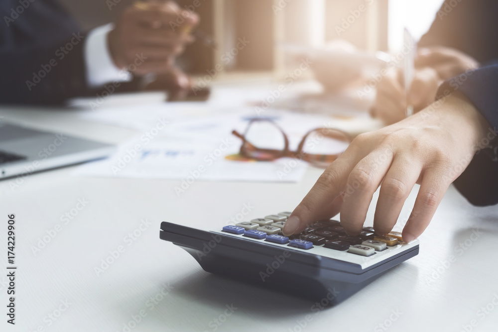 Close up group of business calculator and laptop for calaulating finance, tax, accounting, statistics and analytic research concept Close up group of business calculator and laptop for calaulating finance, tax, accounting, statistics and analytic research concept