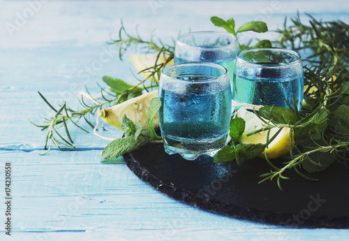 Blue curacao liqueur or sambuca with lemon