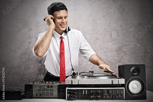 Formally dressed man playing music on a turntable