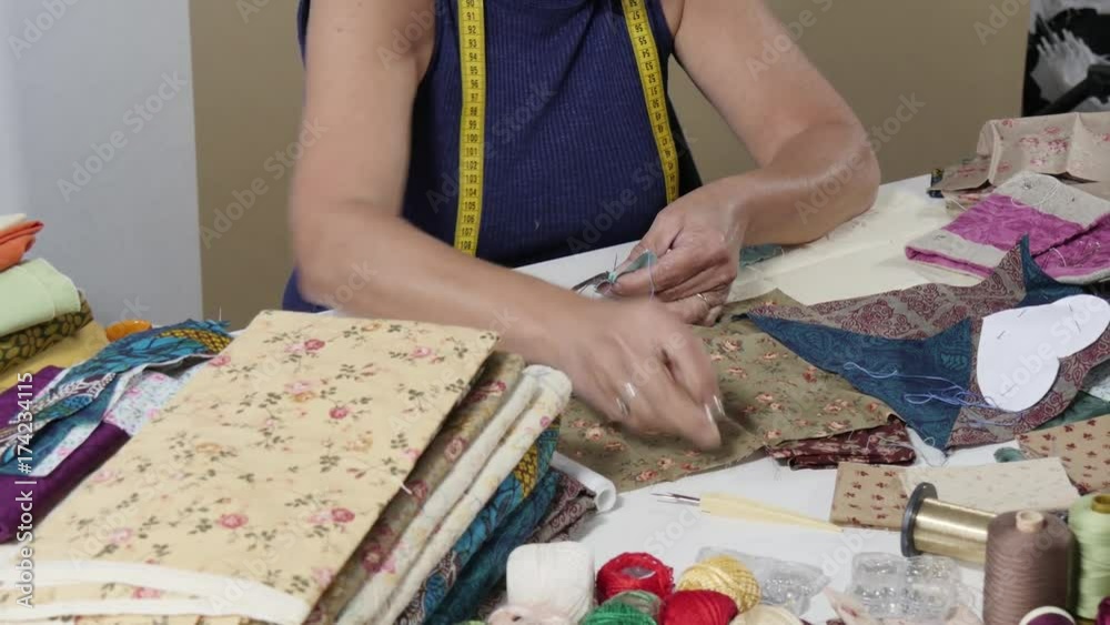 seamstress woman hands sewing for finish a quilt. seamstress woman hands sewing for finish a quilt.