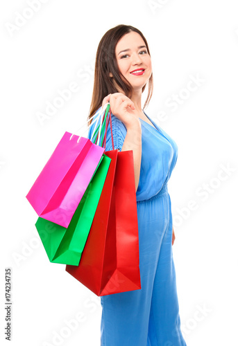 Beautiful stylish overweight woman with shopping bags on white background