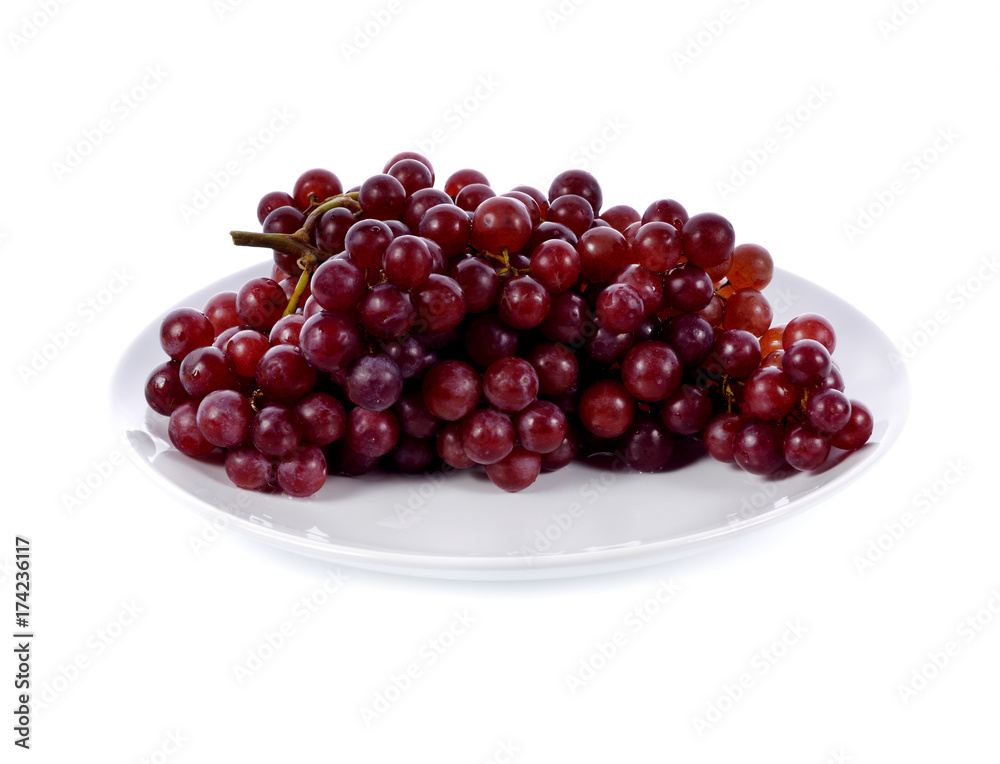 Red grape bunch in white plate isolated on white background Red grape bunch in white plate isolated on white background