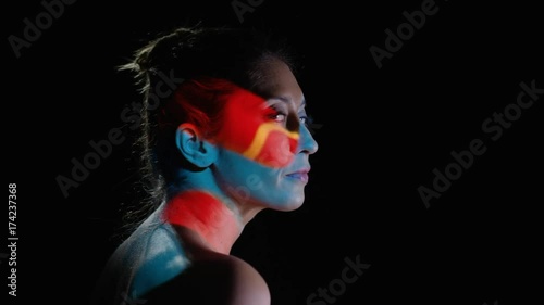  Colorful patterns of light projected onto the face & body of attractive model photo