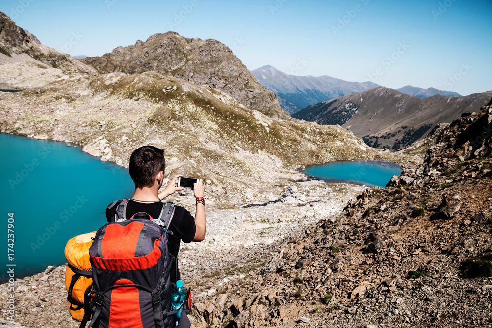 Man shooting the lake in the mountains