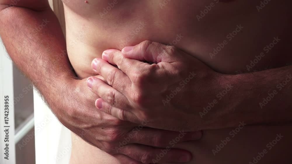Pain symptoms - abdominal ache. Closeup of man feeling bad and ill, suffering from painful abdomen or stomach. Health care and medicine concepts. Pain symptoms - abdominal ache. Closeup of man feeling bad and ill, suffering from painful abdomen or stomach. Health care and medicine concepts.