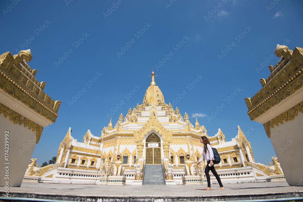 Fototapeta premium 15 December 2016 Female tourist walking at Swe Taw Myat, Buddha Tooth Relic Pagoda a famous and beautiful buddhist temple in yangon , myanmar