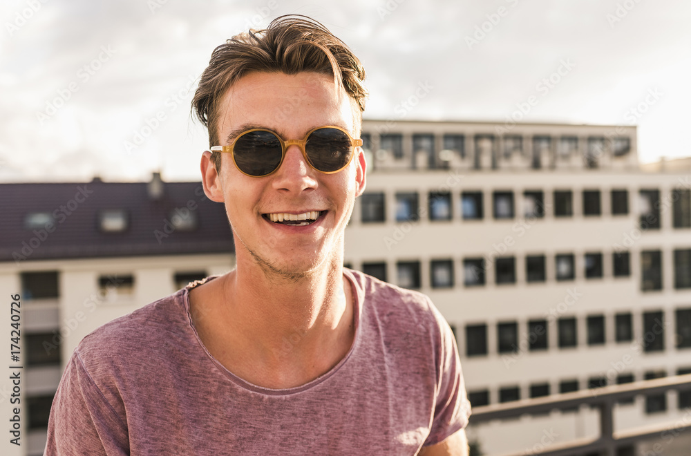 Portrait of happy young man on rooftop Portrait of happy young man on rooftop
