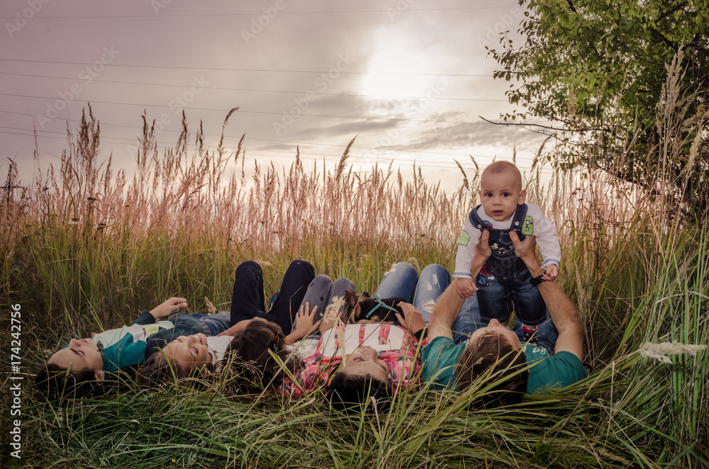 Happy young family spending time together outside in green nature.