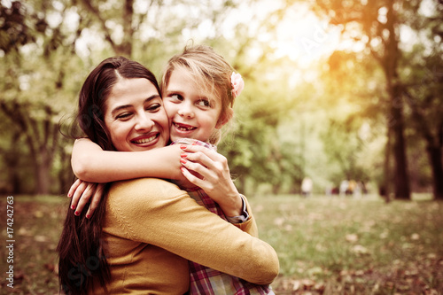 Mother and daughter outdoors in a meadow. Mother and daughter spending time in nature.